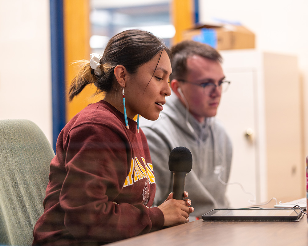A student records their voice during an indigenous language revitalization project.