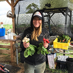 student holding vegetables