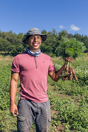 Kyle Sanders picking carrots