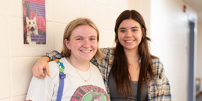 Two students smiling