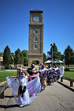 Ballet Folklorico de Durango dancers near clocktower
